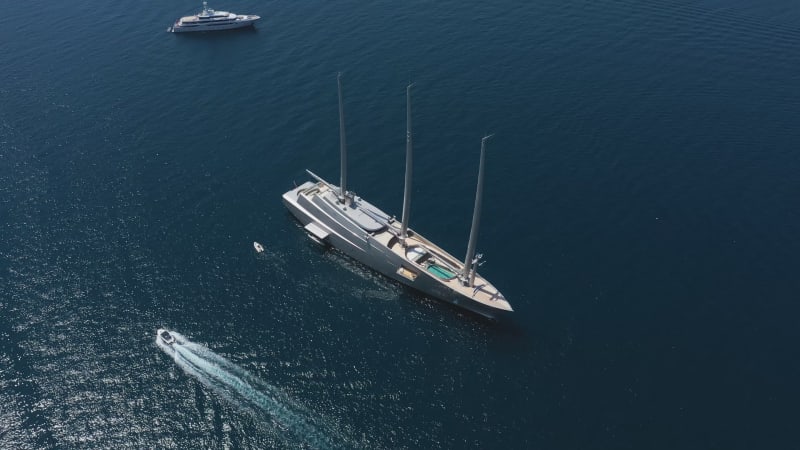 Aerial view of a yacht and many boats along the coast, France.