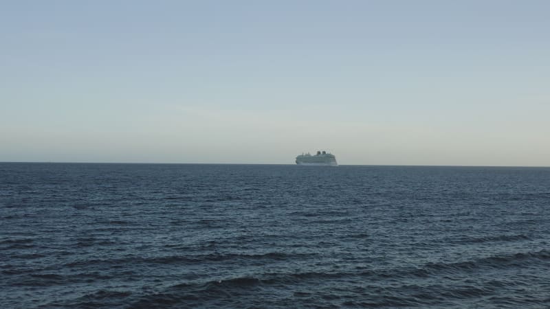 Aerial View of Ocean with Distant Cruise Ship