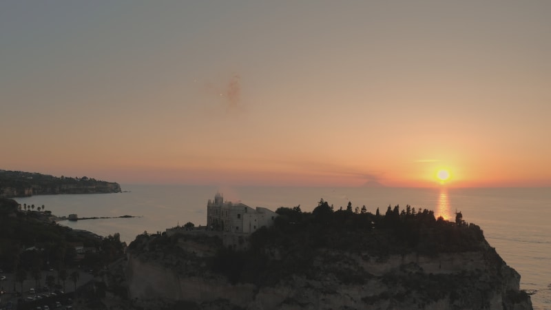 Aerial view of the fireworks at the sanctuary in Tropea beach during sunset