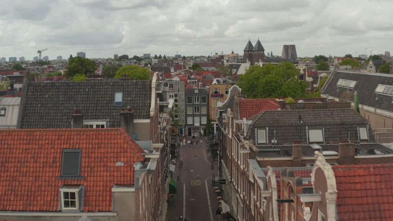 Slow forward Aerial above typical Amsterdam Neighbourhood Street and Tilt Down on Canal Bridge