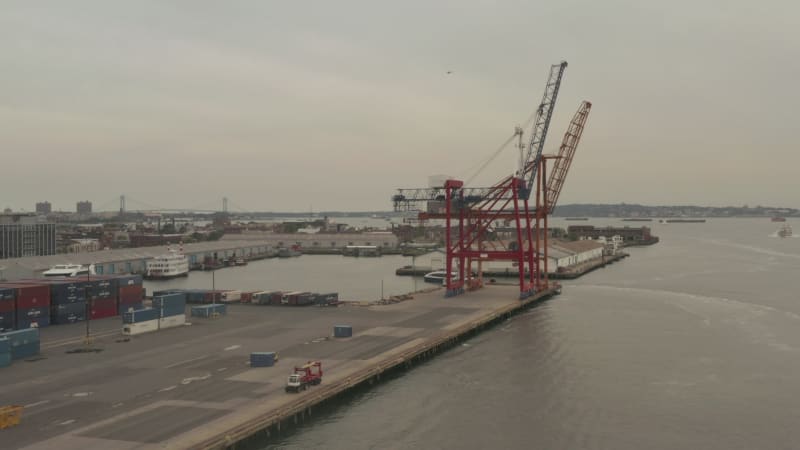 Close Up of industrial cranes in docks in New York City on cloudy day