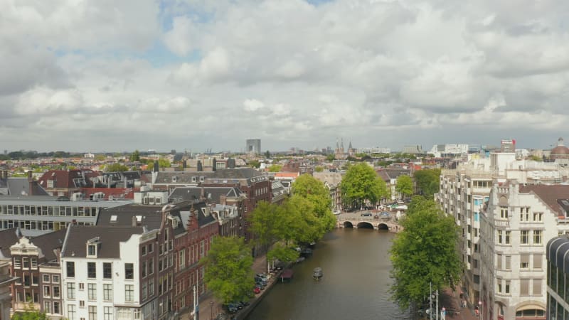 Amsterdam Cityscape above Canal on a Cloudy Day, Aerial Forward