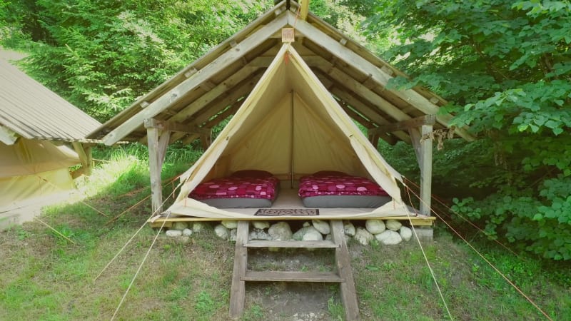 Tracking shot of tent in an eco camping.