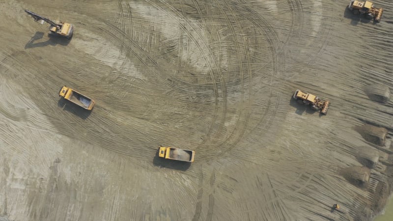 Aerial view of a crane operating in a big wasting dump, Dhaka, Bangladesh.