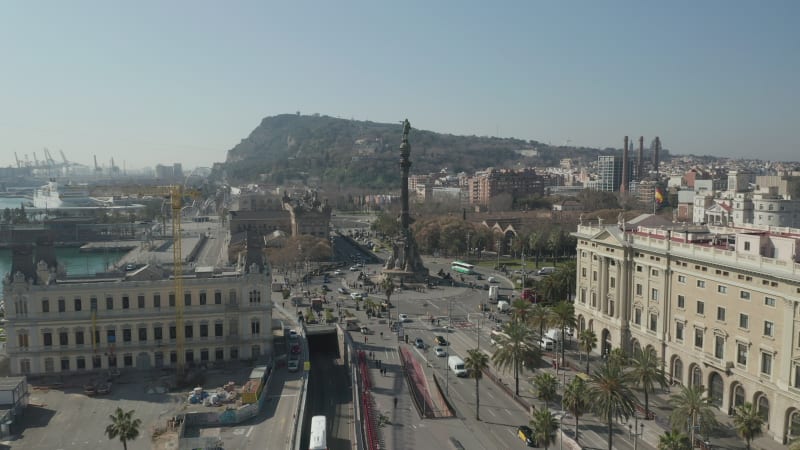 Dolly in towards Columbus Monument in Barcelona, Spain with Palm Trees on Beautiful Sunny Day