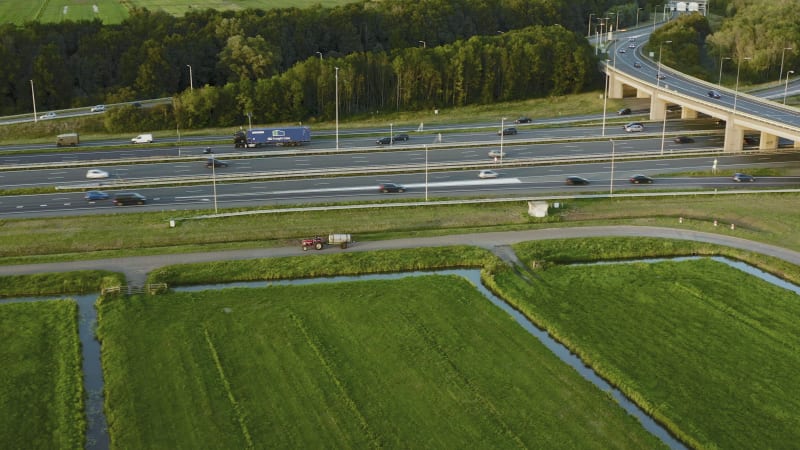 Farmer Riding Tractor Along A12 Highway in Utrecht, Netherlands