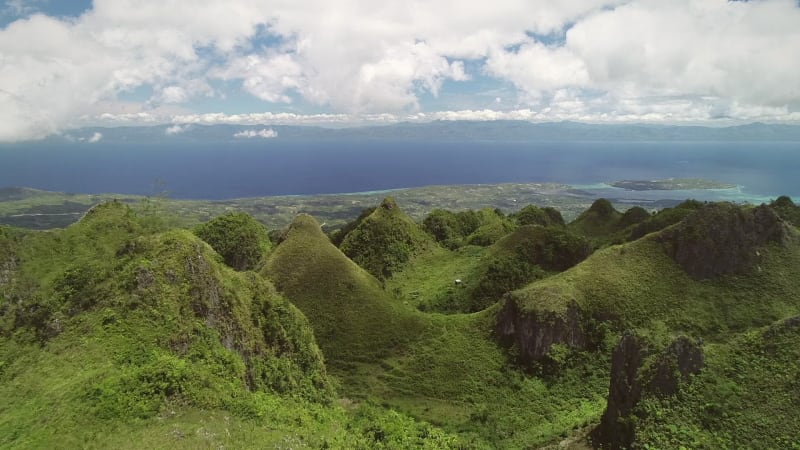 Aerial view of peak Chocolate hills and cloudy sky in Badian.