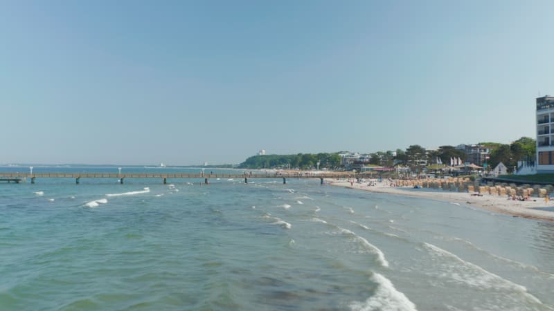 Scenic summertime travel destination beach in Scharbeutz, Germany, Baltic sea, sunny day, dolly in