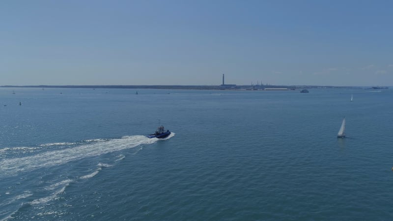 Tug Boat Moving Through the Sea in the Summer