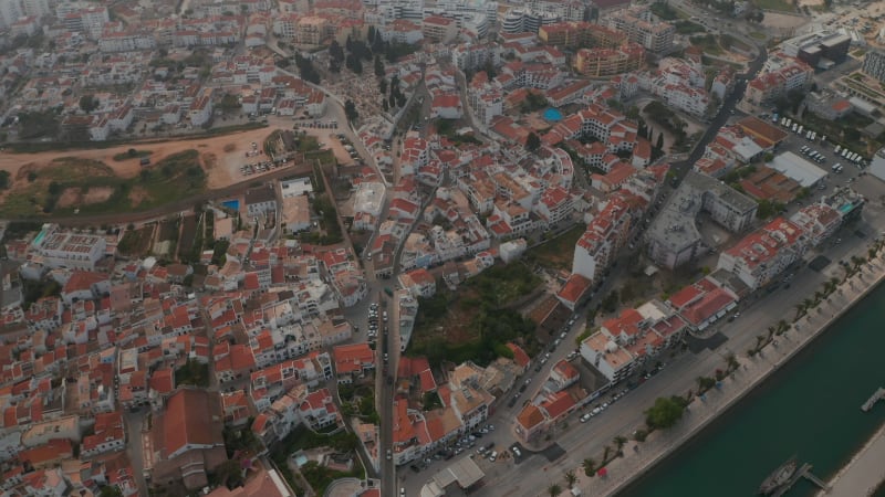 Scenic aerial drone view of Lagos cityscape buildings, Algarve, Portugal, dolly in, day