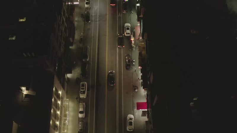 Overhead Top Down Follow Shot of Vehicle Car driving on Dark Road at Night in Chinatown, Manhattan, New York City