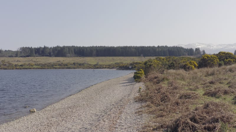 Empty Pebble Shores of a Lake Aerial Flyover