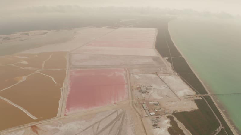 Aerial panoramic view of sea salt evaporation site with system of colourful ponds. Las Coloradas, Yucatan, Mexico