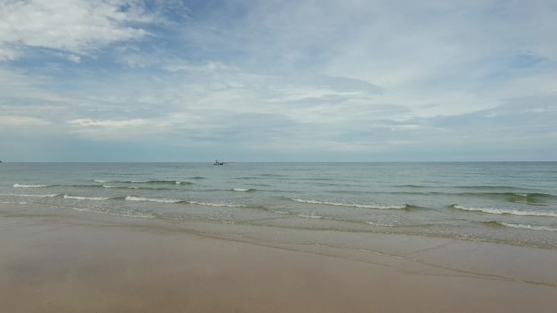 Aerial view of small fishing boat navigating on calm water, Ko Chang.