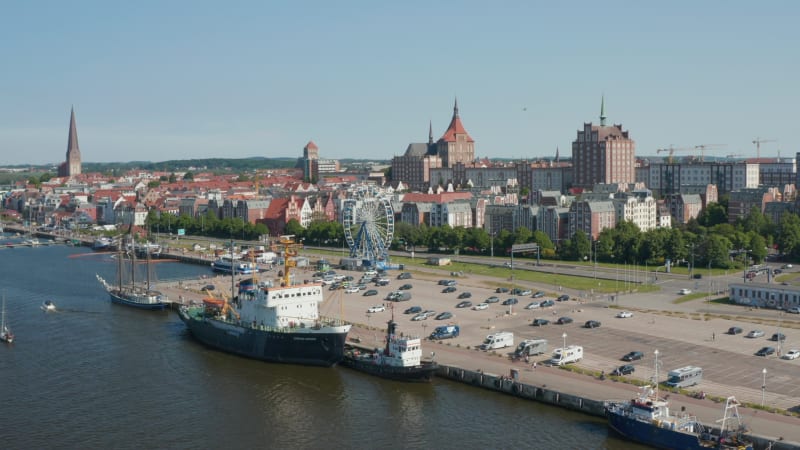 Aerial panoramic view of waterfront and landmarks in historic city centre. Church towers towering above buildings