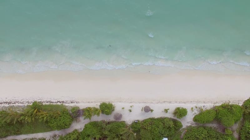 Aerial view above of beach with transparent water.