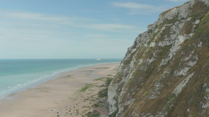 Cruise Ship on Blue water with Cliff in foreground, Cap Blanc-Nez, Aerial forward