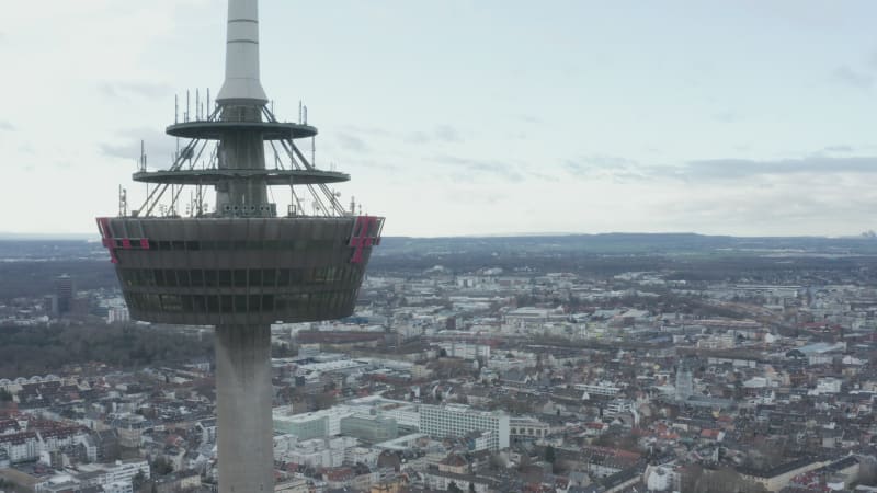 Orbit shot around platform on Colonius telecommunications tower with various antennas. Buildings in city in background. Cologne, Germany