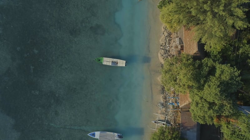 Bird's Eye View of a Picturesque Sandy Beach and Coast With Moored Fishing Boats