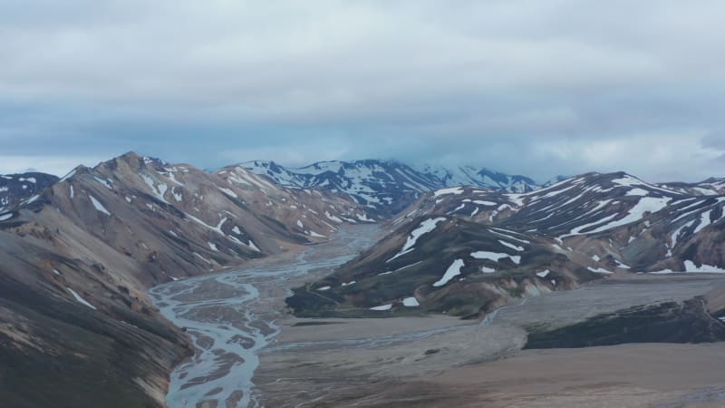 Birds eye of beautiful and unspoiled glacier snowy Thorsmork valley in Iceland. High angle view of Porsmork icelandic highlands with Krossa river and mossy cliffs. Amazing on earth