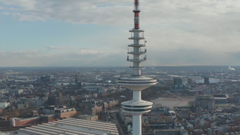 Close up aerial view of observation deck on top of Heinrich Hertz TV tower rising above Hamburg cityscape