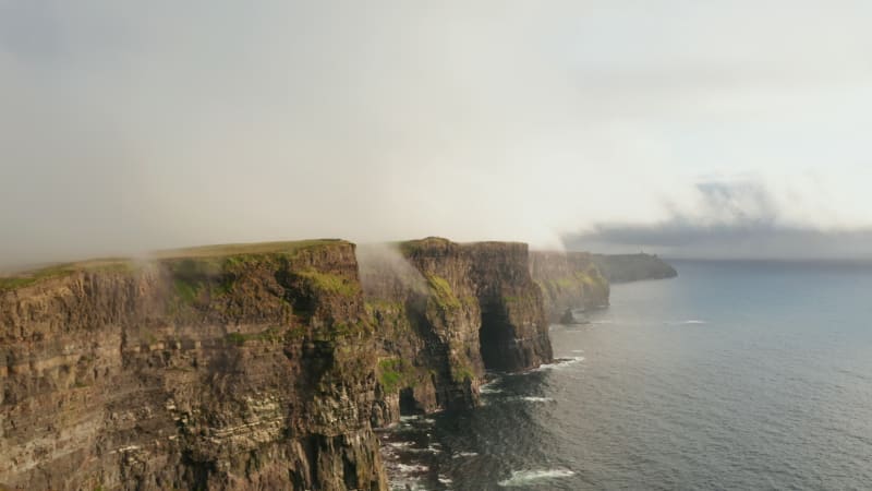 Amazing panoramic view of high cliffs above rippled sea. Beautiful coastal scenery. Cliffs of Moher, Ireland