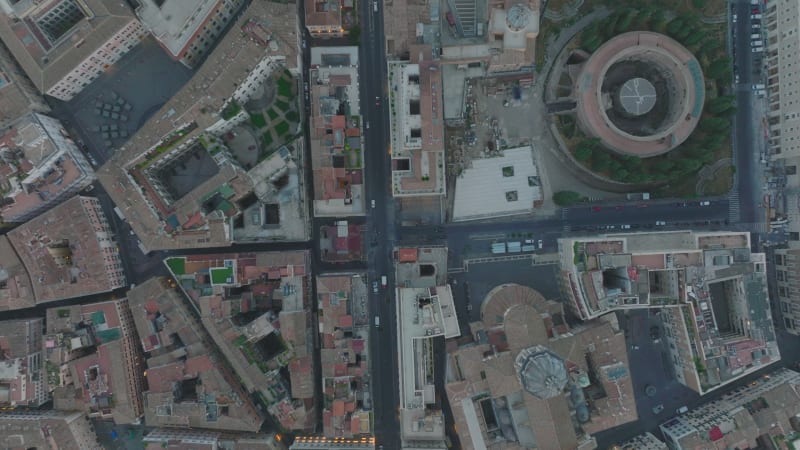 Birds eye shot of historic buildings and sights in city centre. Fly over San Carlo al Corso and Mausoleum of Augustus. Rome, Italy