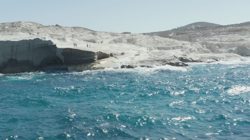 Aerial View of Sarakiniko Beach with Heave Waves crashing into rocks in Milos, Greece