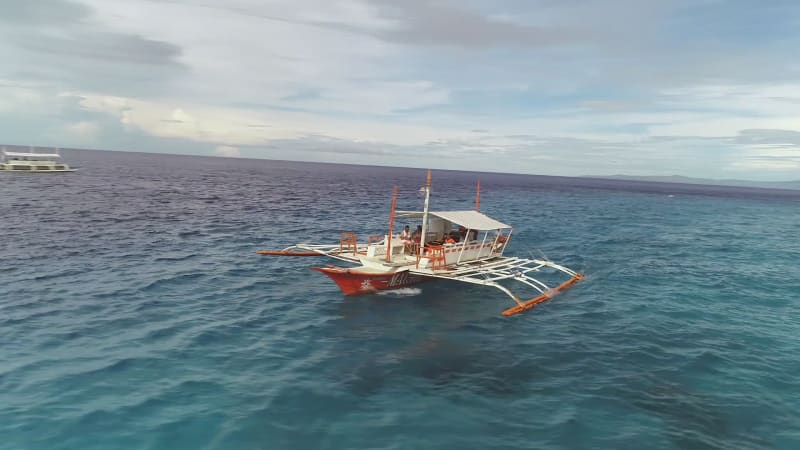 Aerial view of single filipino fishing boat near Lapu-Lapu city.