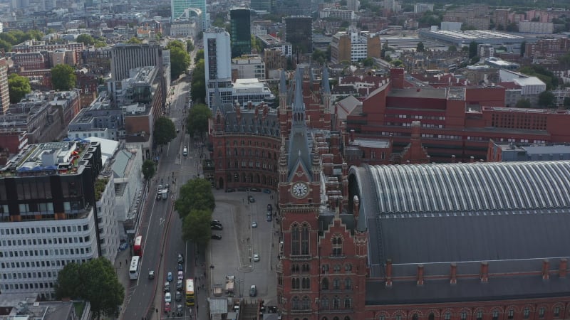 Slide and pan aerial footage of Victorian style brick building of  St Pancras train station and hotel. London, UK