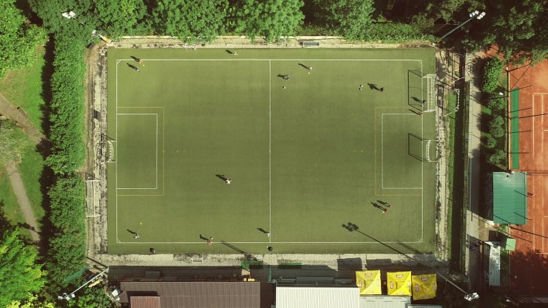 Aerial view of a football training in a football pitch on a summer day.