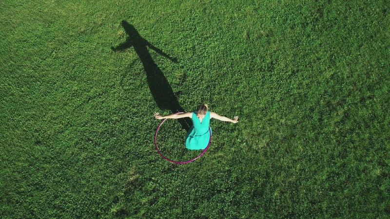 Aerial view of a woman with Hula Hoop in a park, Zagreb, Croatia.