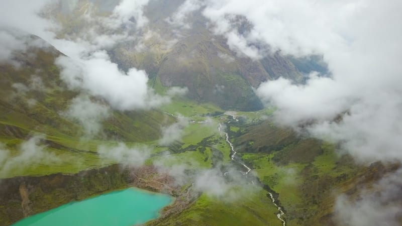 Aerial view of cloudy, snowy Humantay Lake.