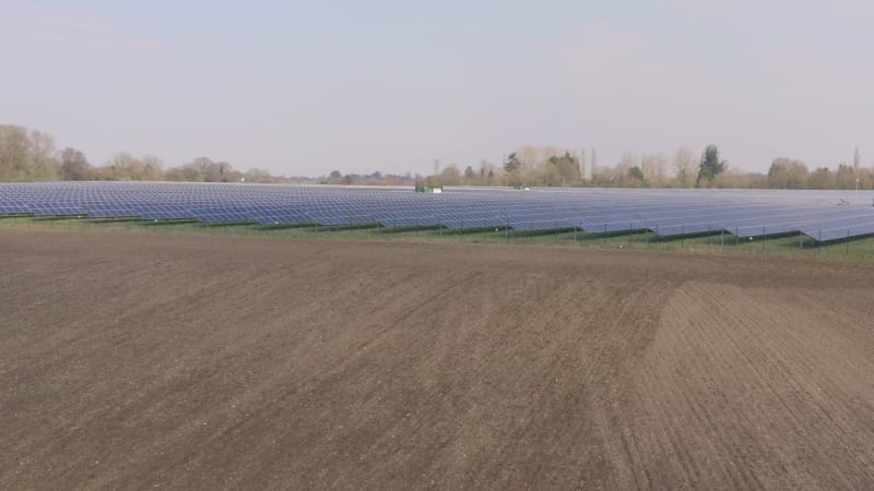 A Solar Farm and Traditional Farming Side By Side