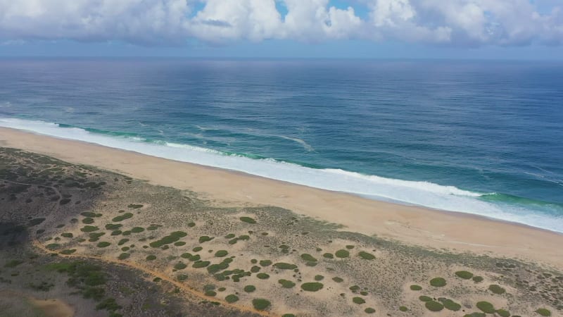 Aerial view of sandy beaches and waves.