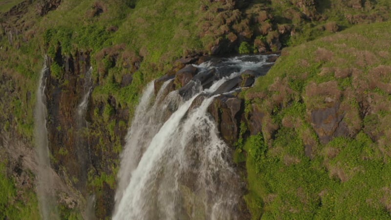 Drone view of stunning highlands and Seljalandsfoss waterfall in southern Iceland. Birds eye view of water flowing from most touristic cascade in icelandic national park