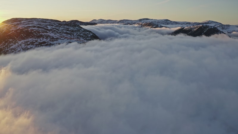 Mountain tops above the clouds in Norway.