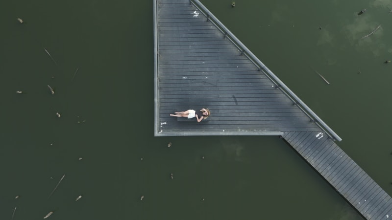 Top down aerial view of a girl at Het Verdronken Bos Pond in Schalkwijk, Netherlands