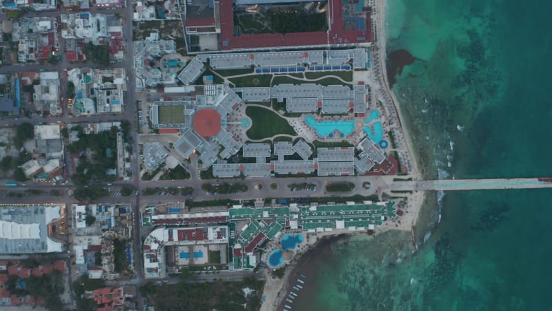 Aerial view with Caribbean resorts and long pier above the sea in Playa del Carmen. Aerial Birds Eye Overhead Top Down View