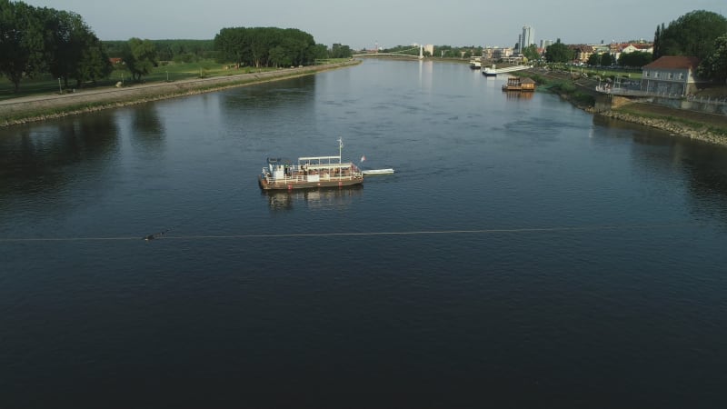 Aerial view of a passenger ferry boat crossing Drava river, Osijek, Croatia.