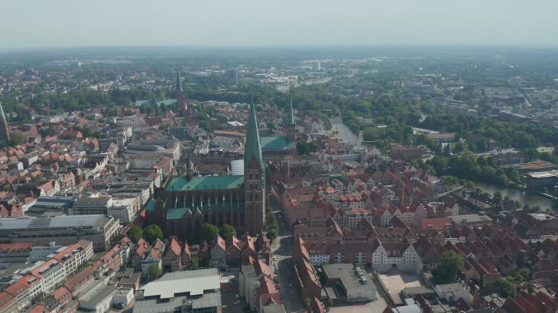 Aerial panoramic footage of old town lined with river. Landmarks in UNESCO world heritage site. Luebeck, Schleswig-Holstein, Germany