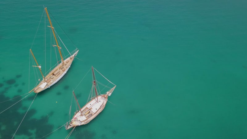 Aerial view of two traditional boats in the mediterranean sea.