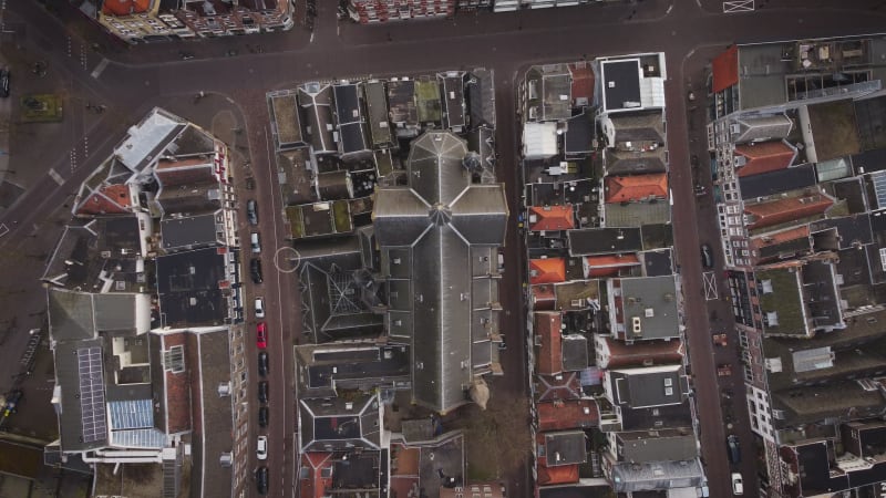 Overhead ascending drone shot of a church and its surrounding in the city center of Utrecht, a city in Netherlands