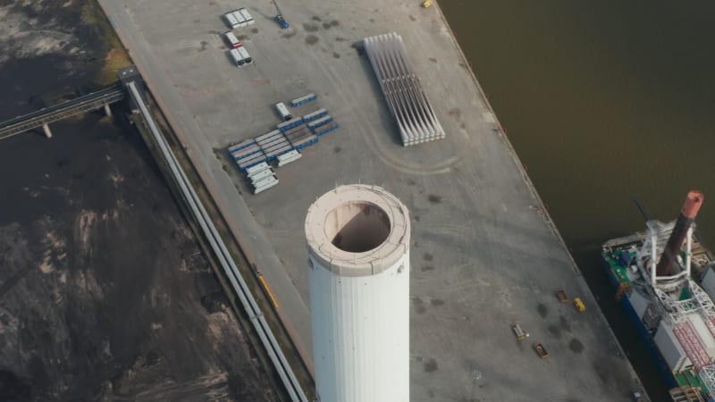 Aerial flight orbiting around the chimney of Esbjerg Power Station in Denmark. The chimney of this station that will be no carbon by 2023 is the tallest in Scandinavia