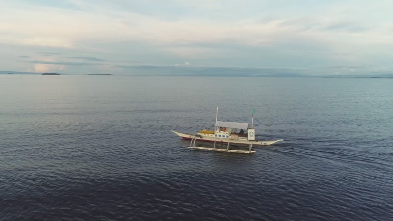 Aerial view of single filipino fishing boat near Lapu-Lapu city.