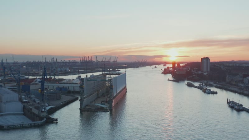 Aerial view of ship building dock in Hamburg port along Elbe river during sunset