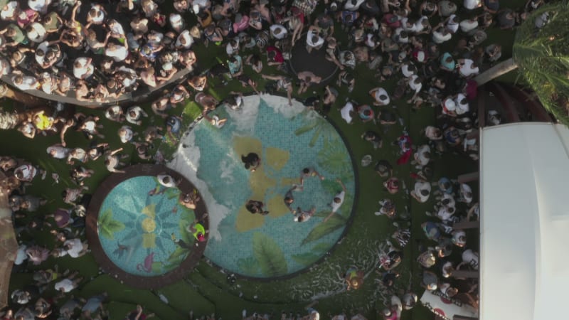 Generic Top View Birds Eye View of Beach Club with pool and people dancing, Aerial Overhead Shot