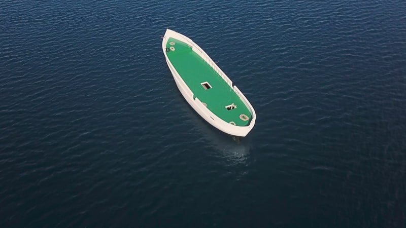 Aerial view of unfinished boat anchored alone at Adriatic sea.