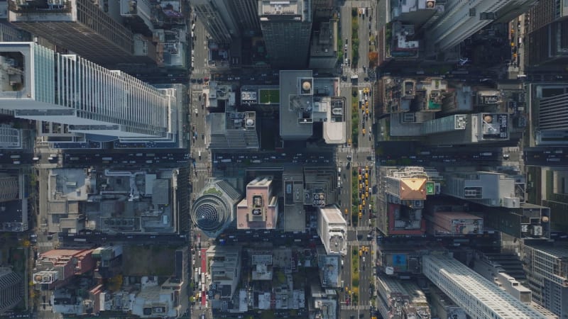 Aerial birds eye overhead top down view of regular blocks of buildings divided by streets. Busy downtown roads. Manhattan, New York City, USA