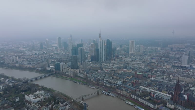 City panorama shot. Aerial hazy view of large town with historic buildings and modern skyscrapers. Frankfurt am Main, Germany